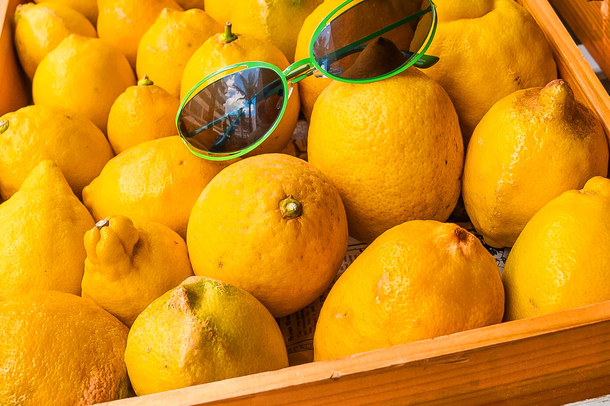 a box of lemons with sunglasses