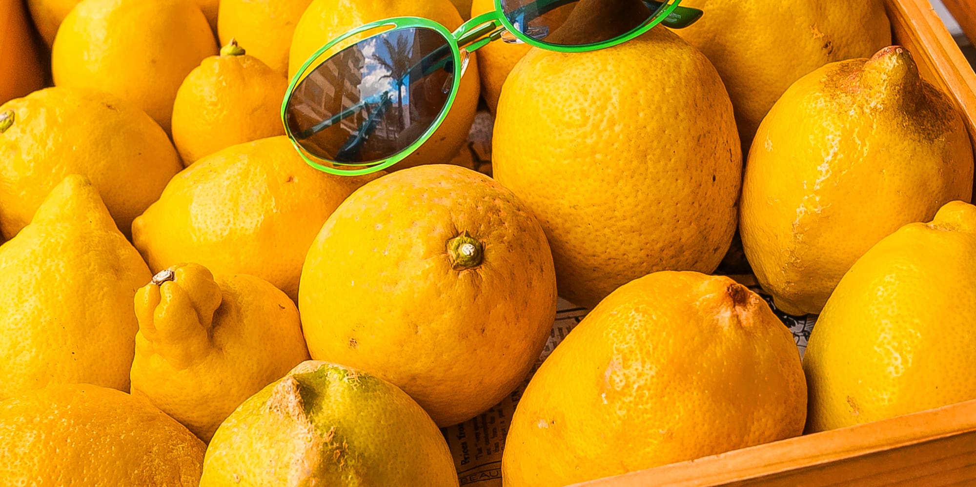 a box of lemons with sunglasses