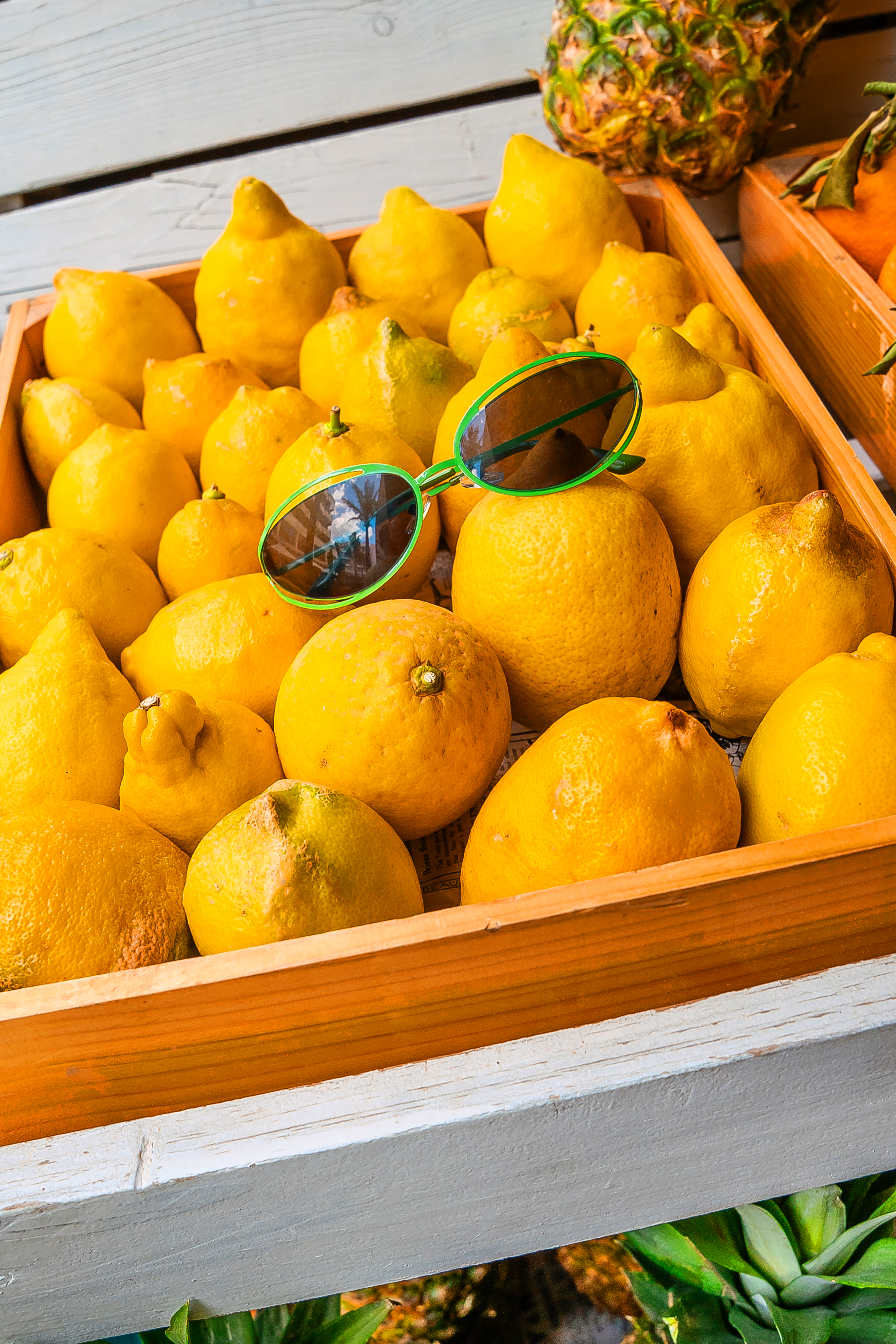 a box of lemons with sunglasses