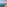 Balcony with ocean view, beach, palm trees, wine, and open book.