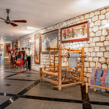 a room with a stone wall and a ceiling fan