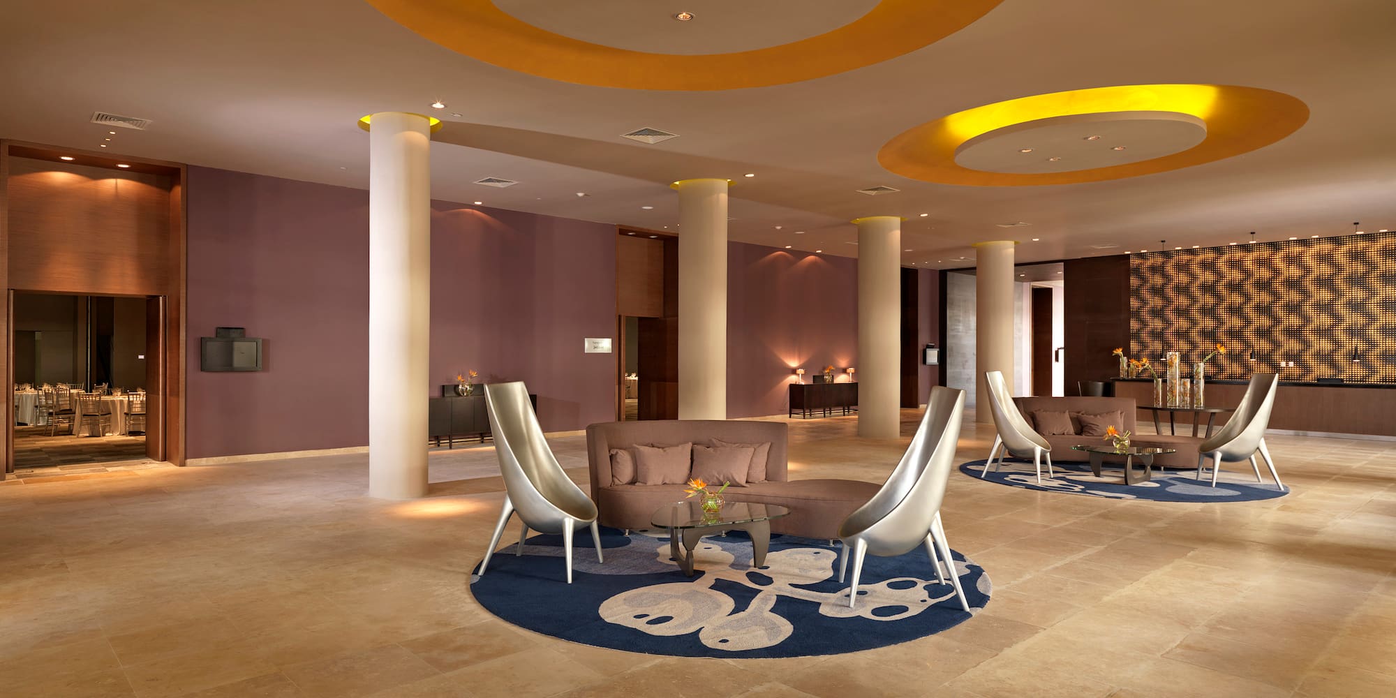 a room with a round table and chairs