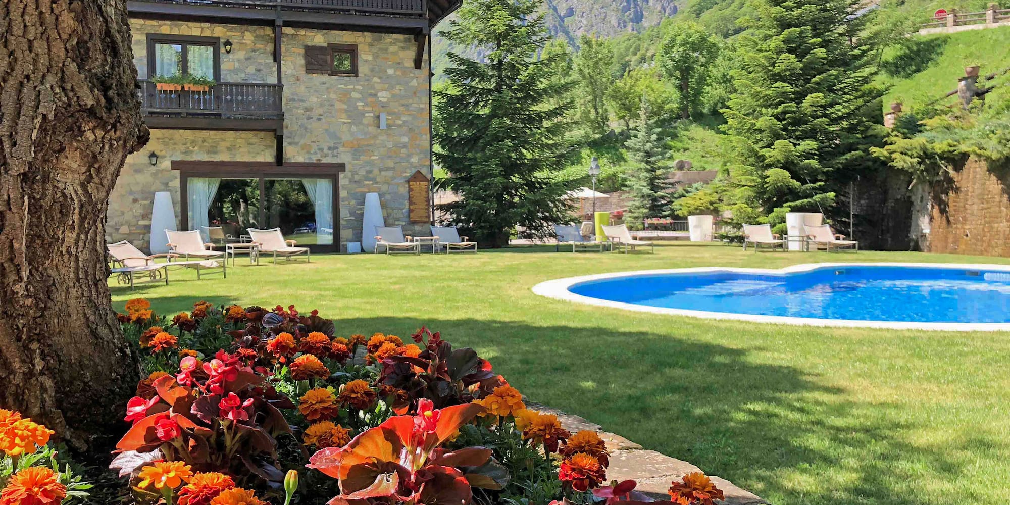 a pool in a house with flowers in front of it