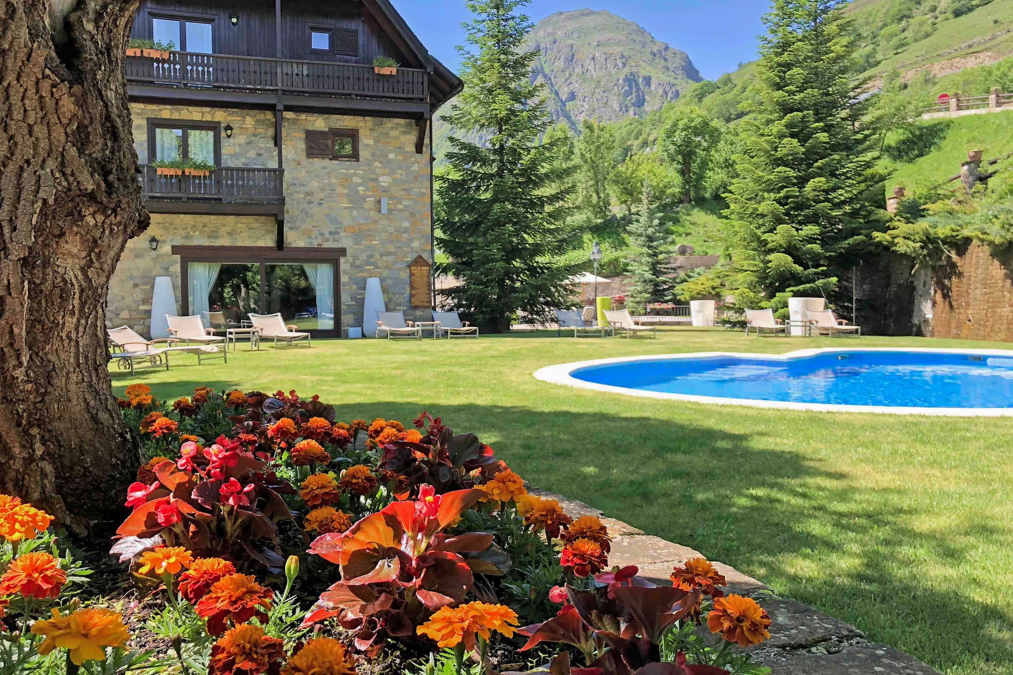 a pool in a house with flowers in front of it