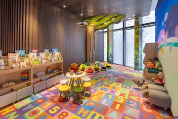 a room with colorful carpet and toys