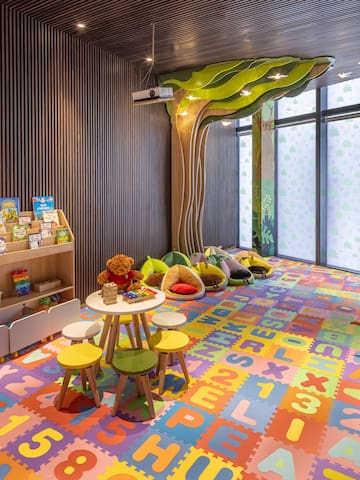 a room with colorful carpet and toys