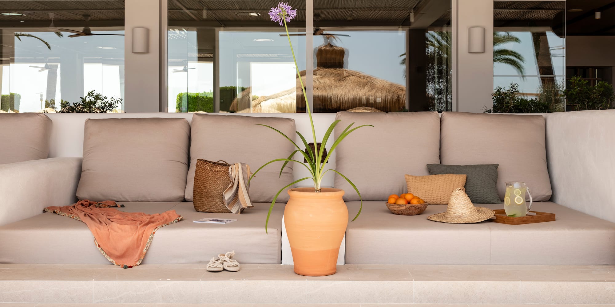 a couch with a potted plant on the steps