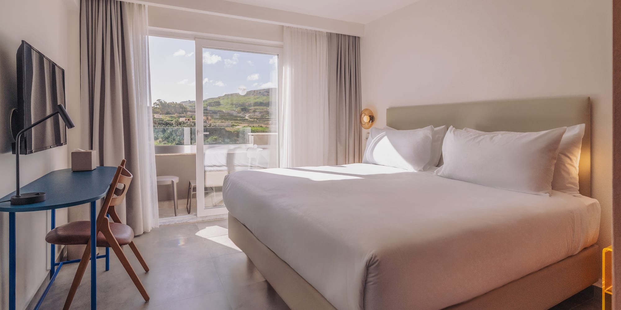 a bed in a room with a glass door