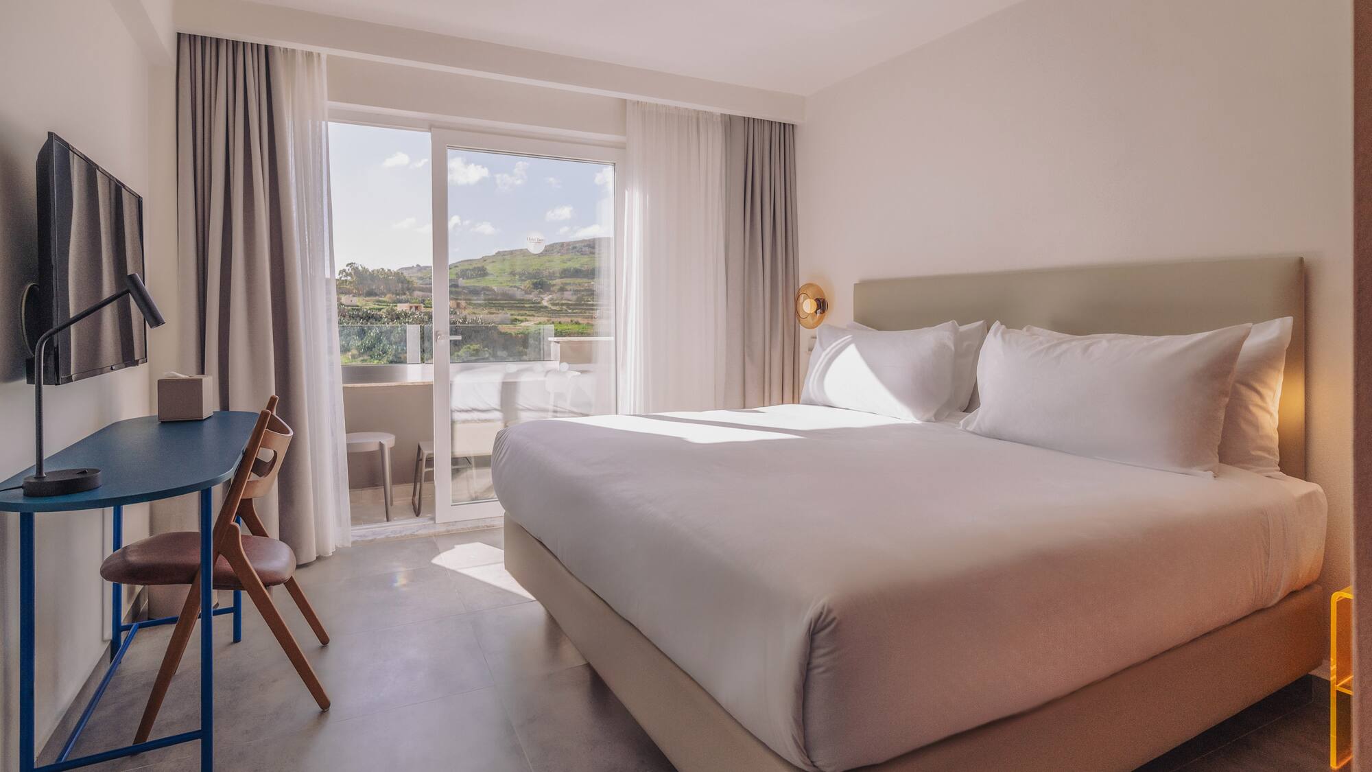 a bed in a room with a glass door