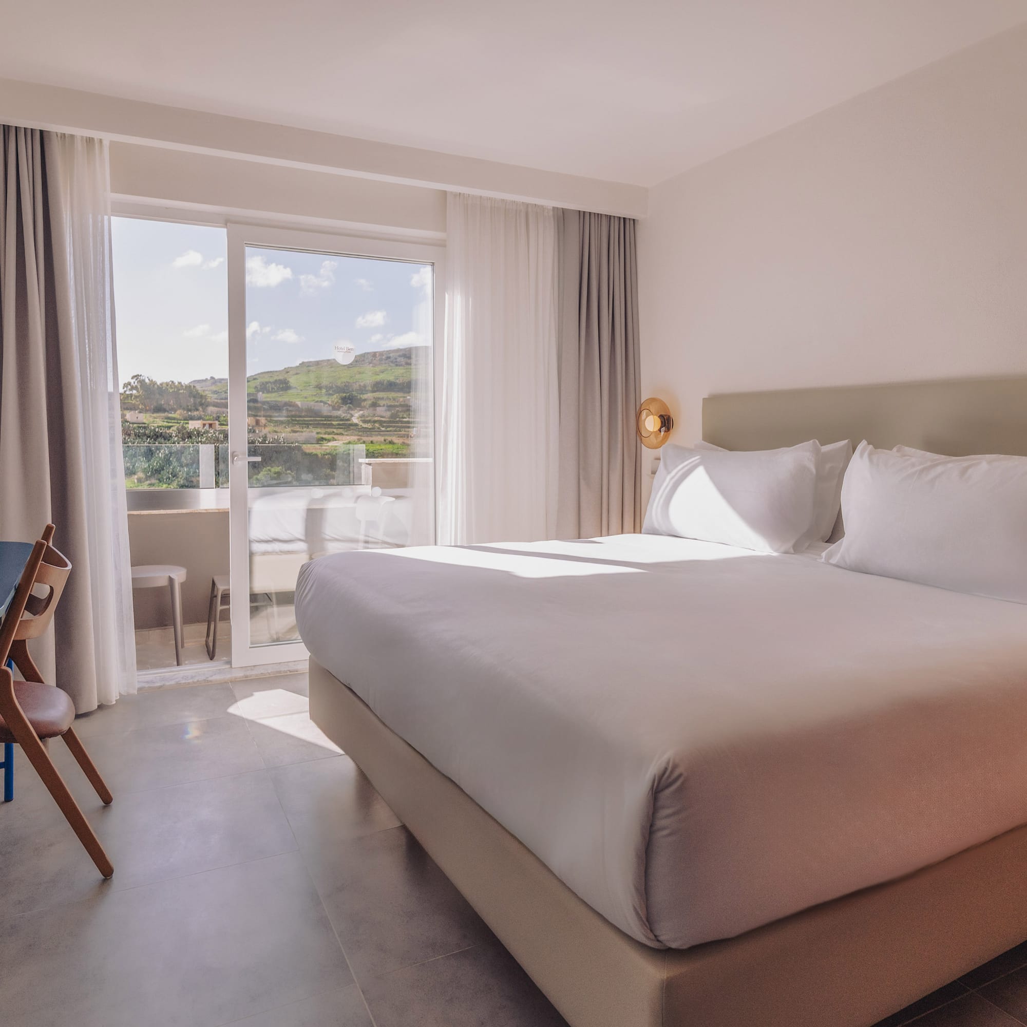 a bed in a room with a glass door