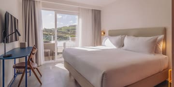 a bed in a room with a glass door