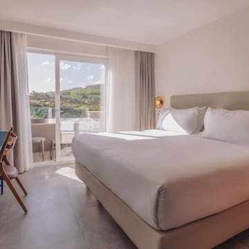 a bed in a room with a glass door