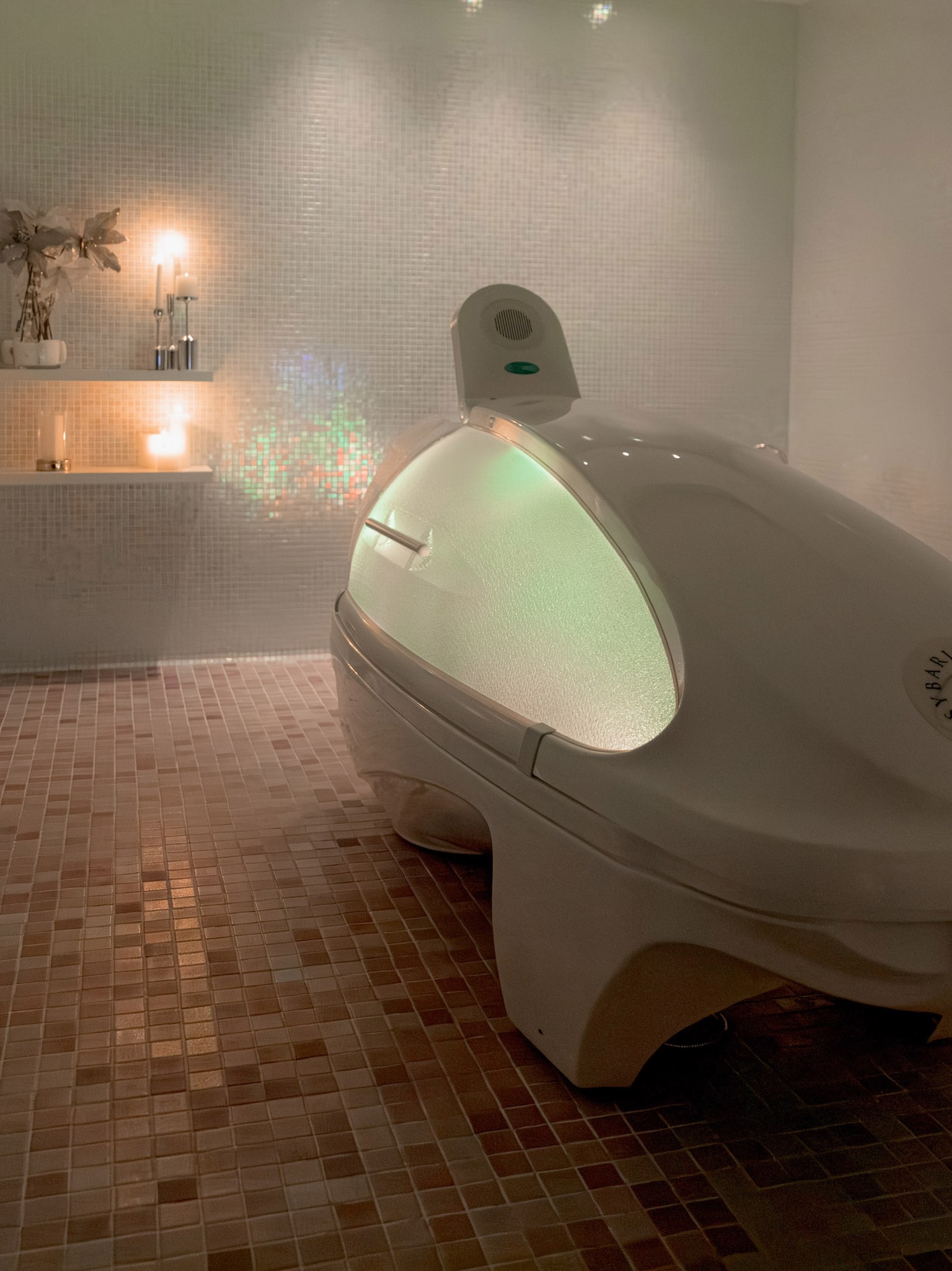 a white oval shaped object in a tiled room