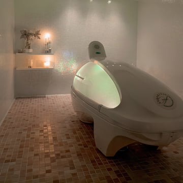 a white oval shaped object in a tiled room