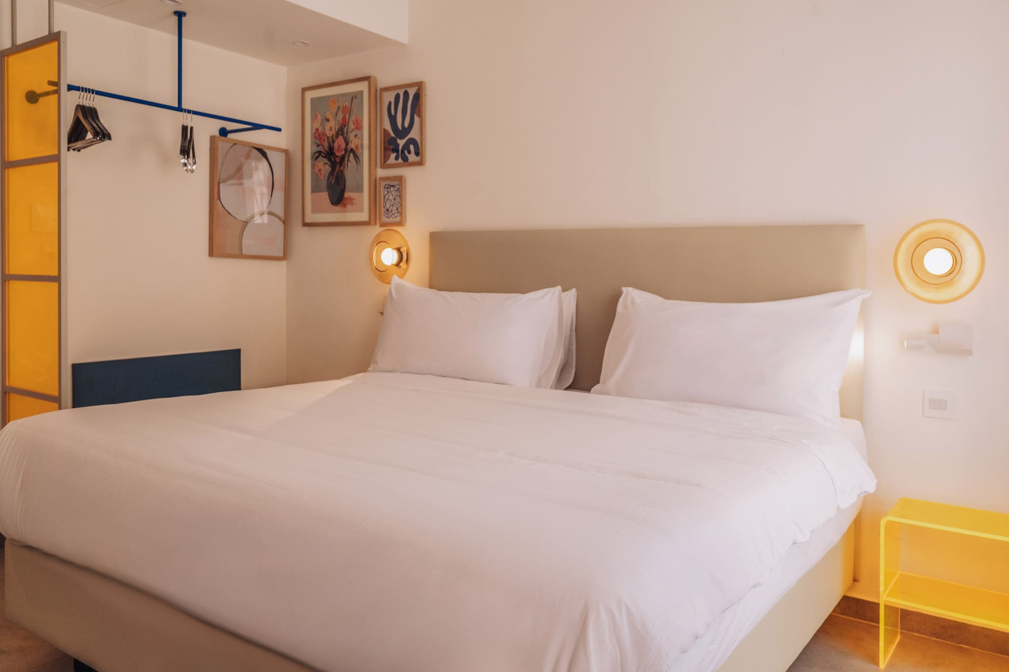 a bed with white sheets and pillows