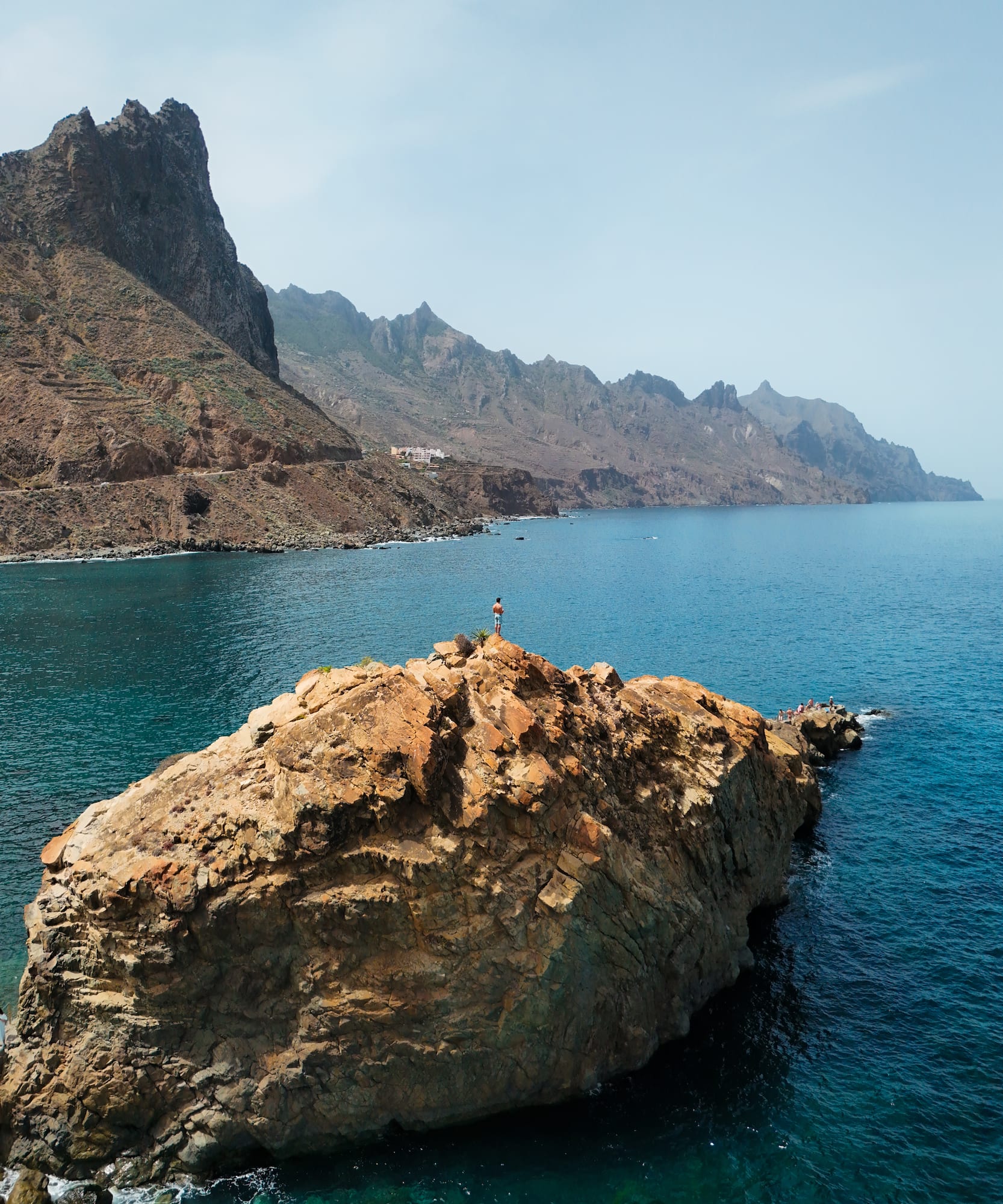 a person standing on a rock in the water