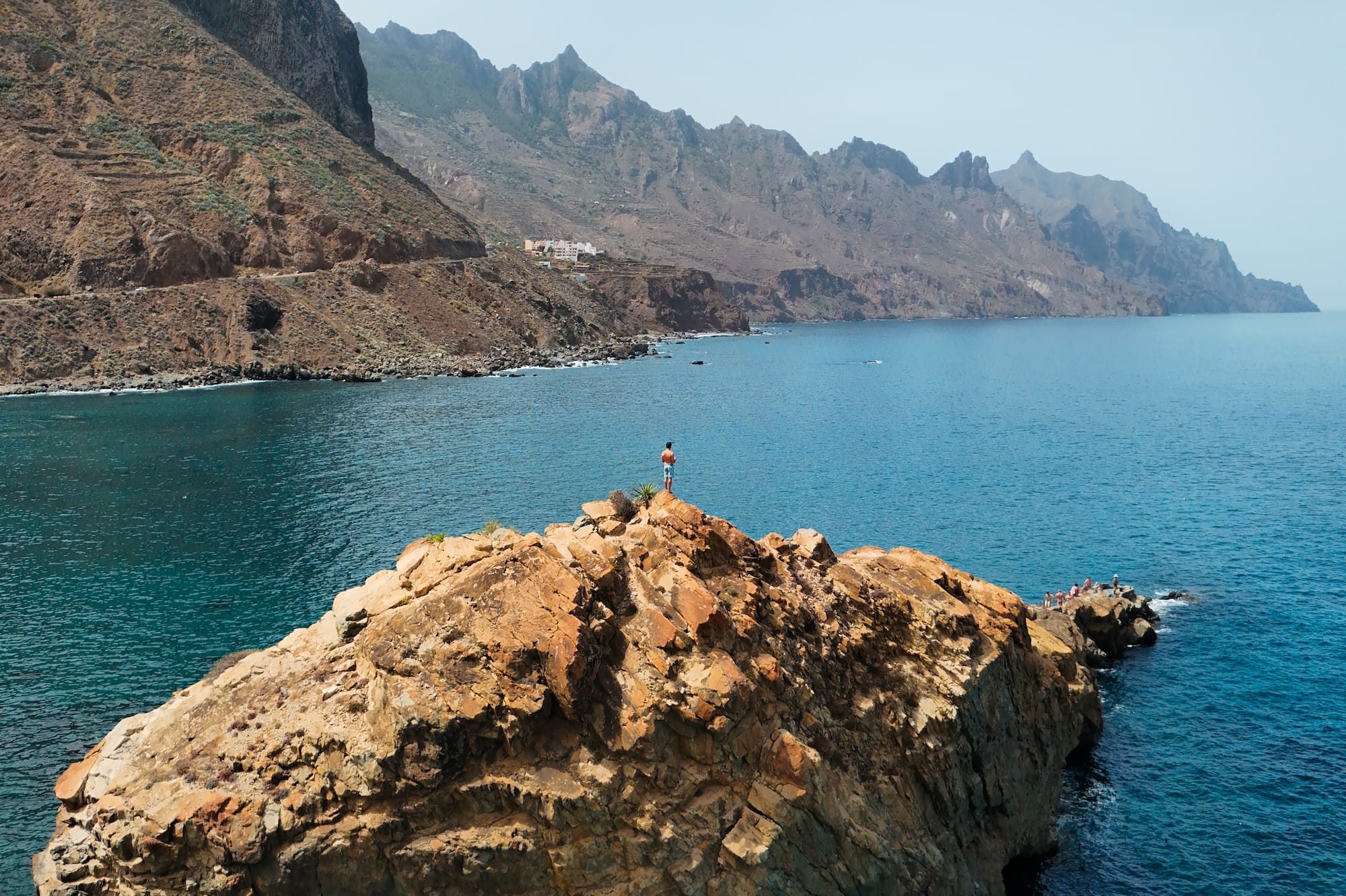 a person standing on a rock in the water
