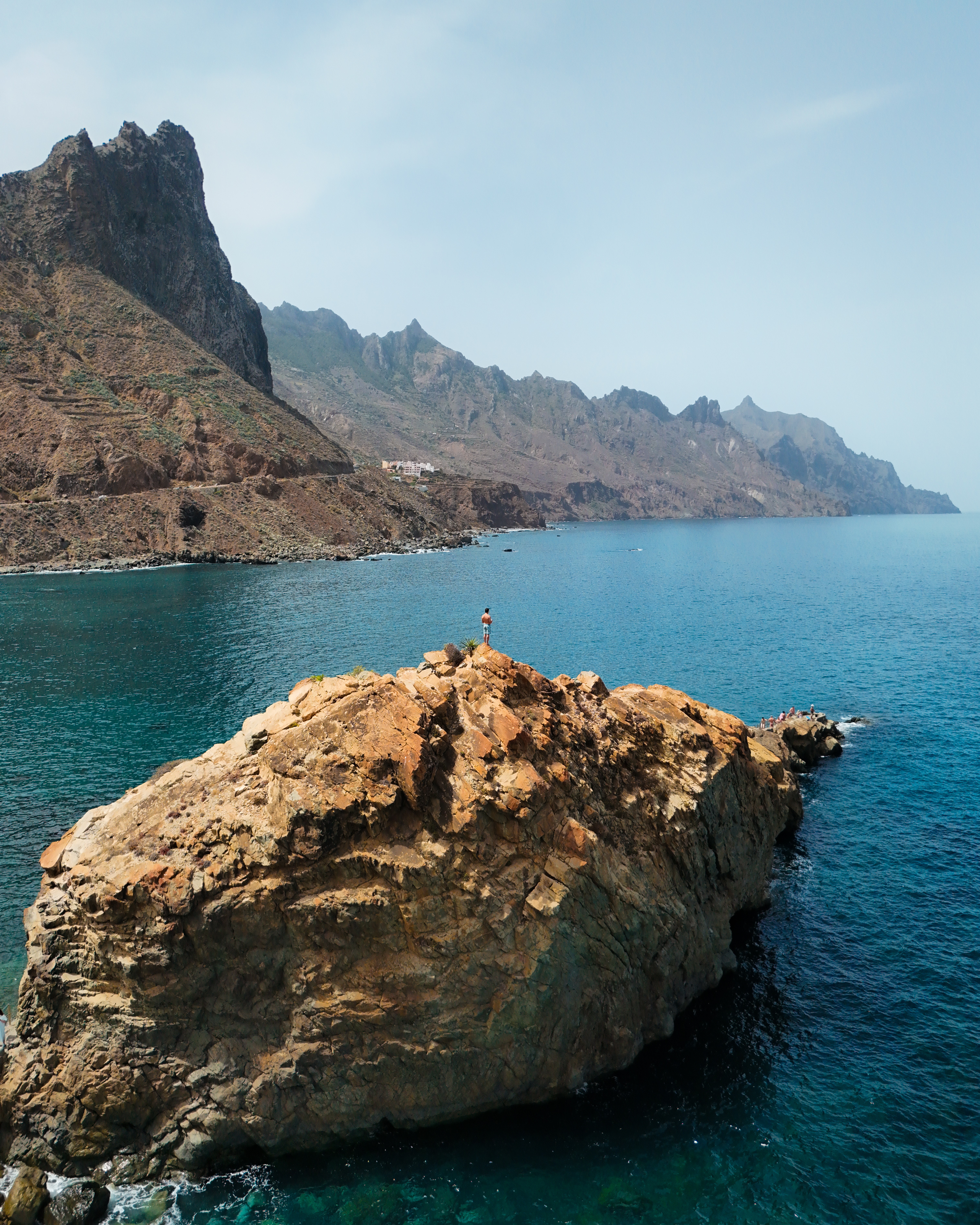 a person standing on a rock in the water