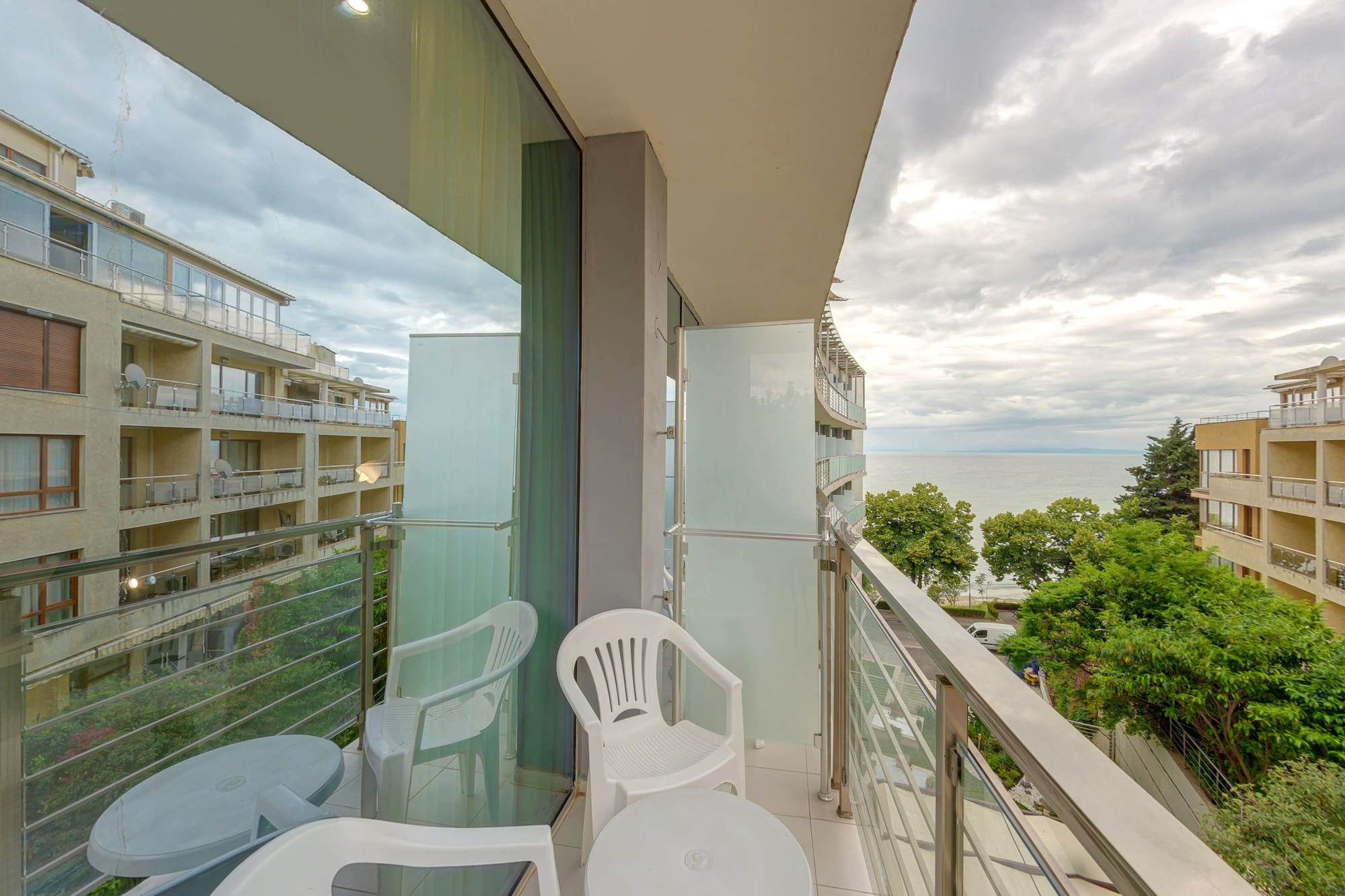 a balcony with chairs and a table