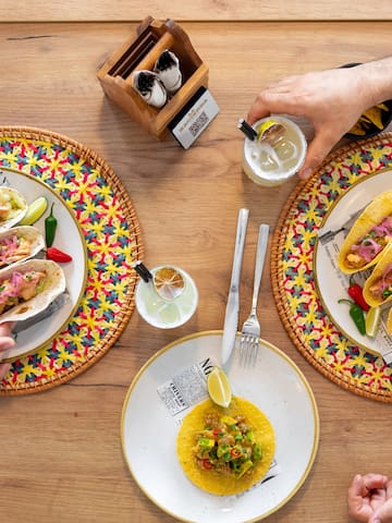 a group of people eating tacos on plates