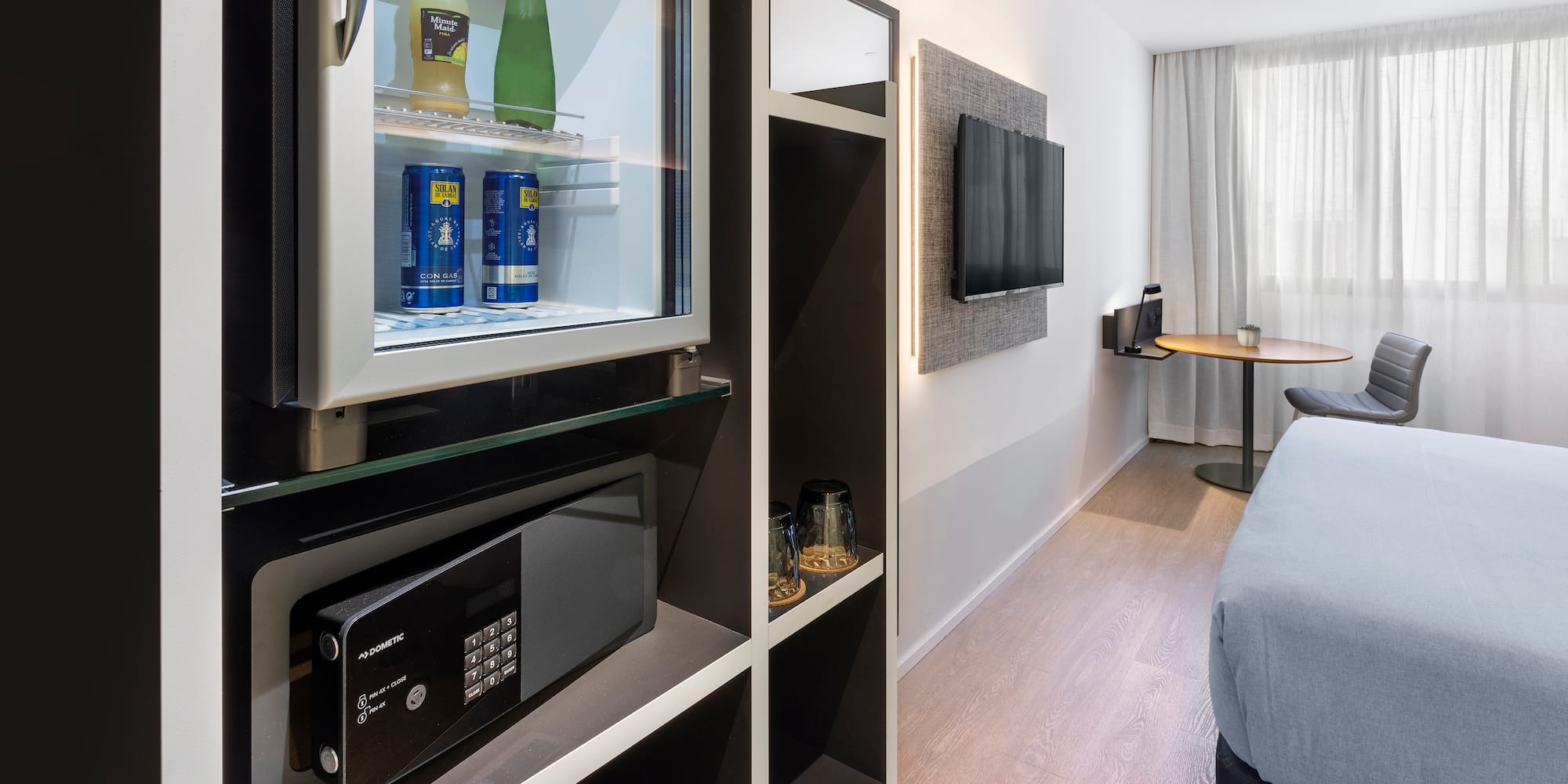 a room with a television and a refrigerator