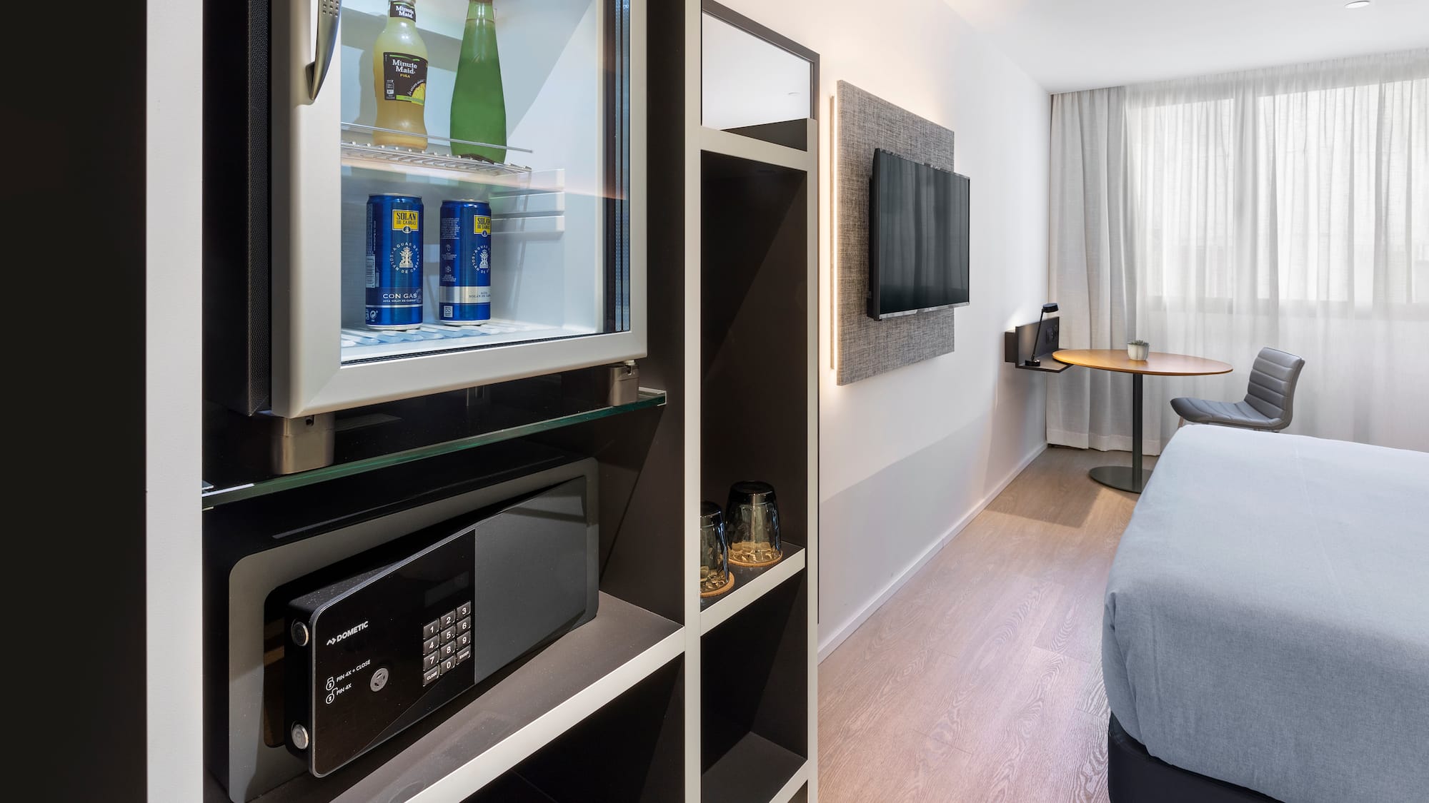 a room with a television and a refrigerator