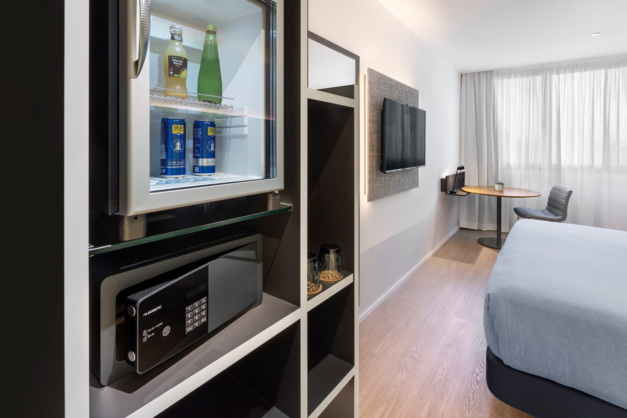 a room with a television and a refrigerator