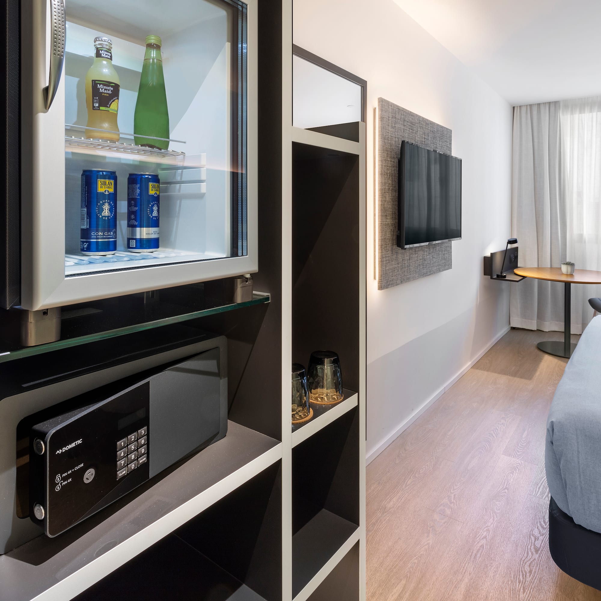 a room with a television and a refrigerator