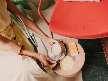 a person holding a cup of coffee