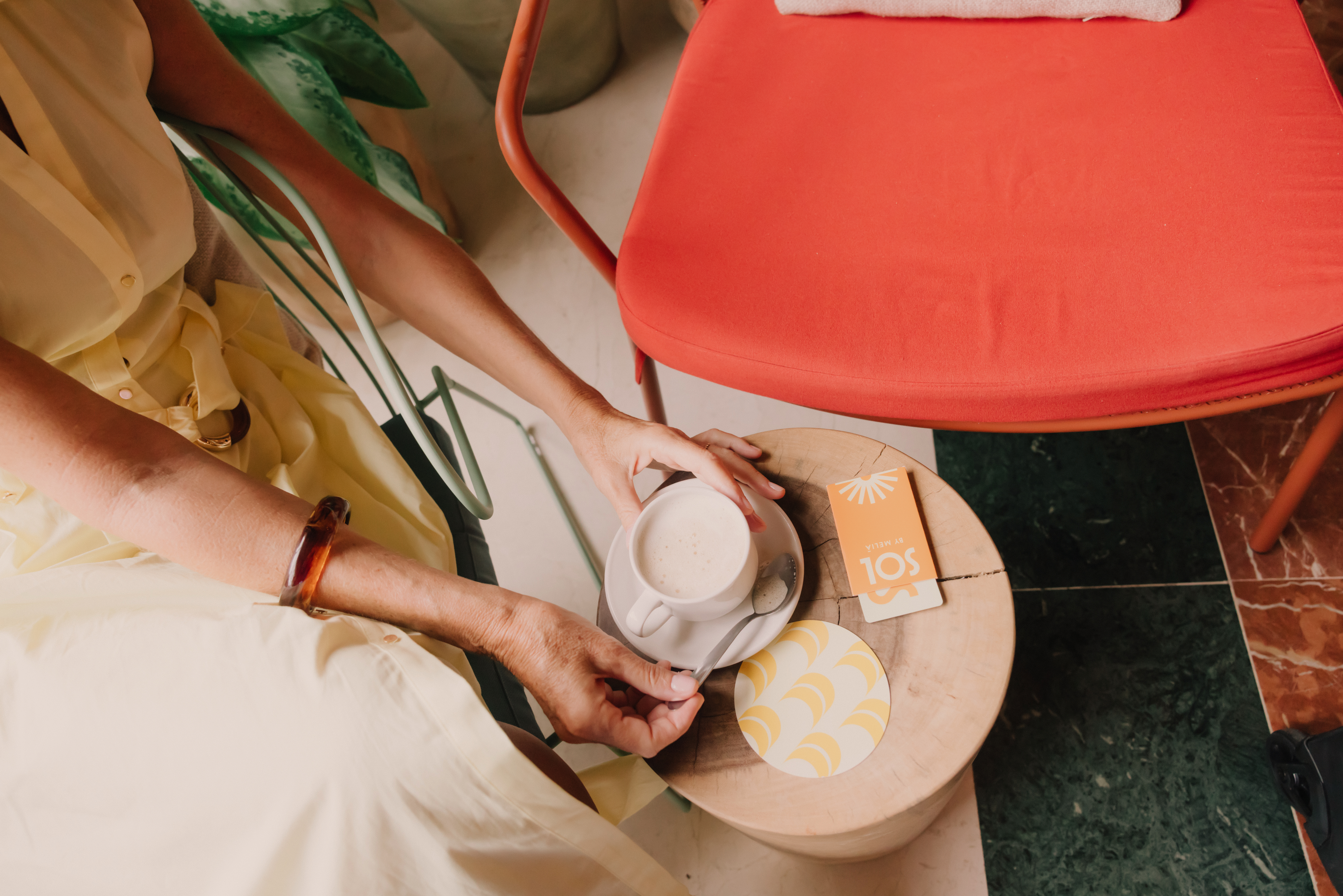a person holding a cup of coffee