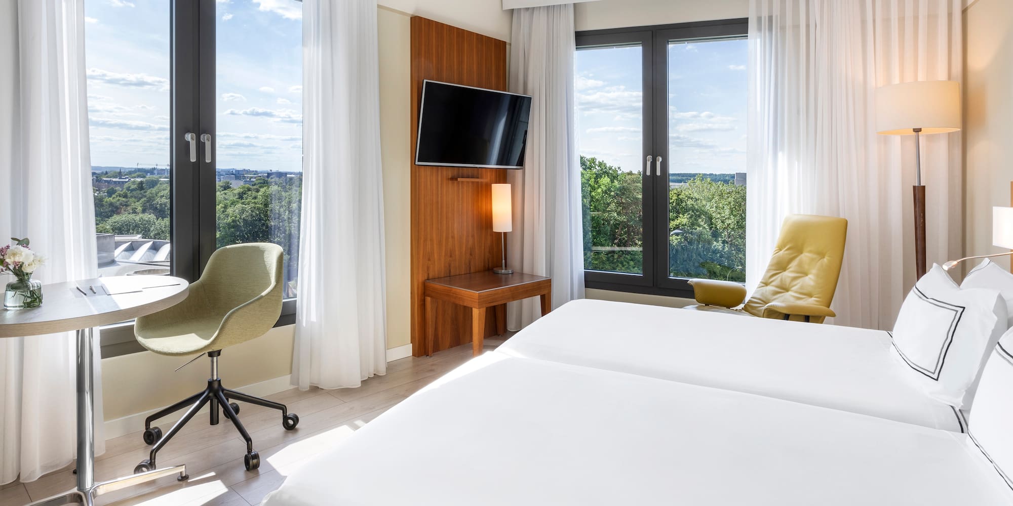 a room with a bed and a television