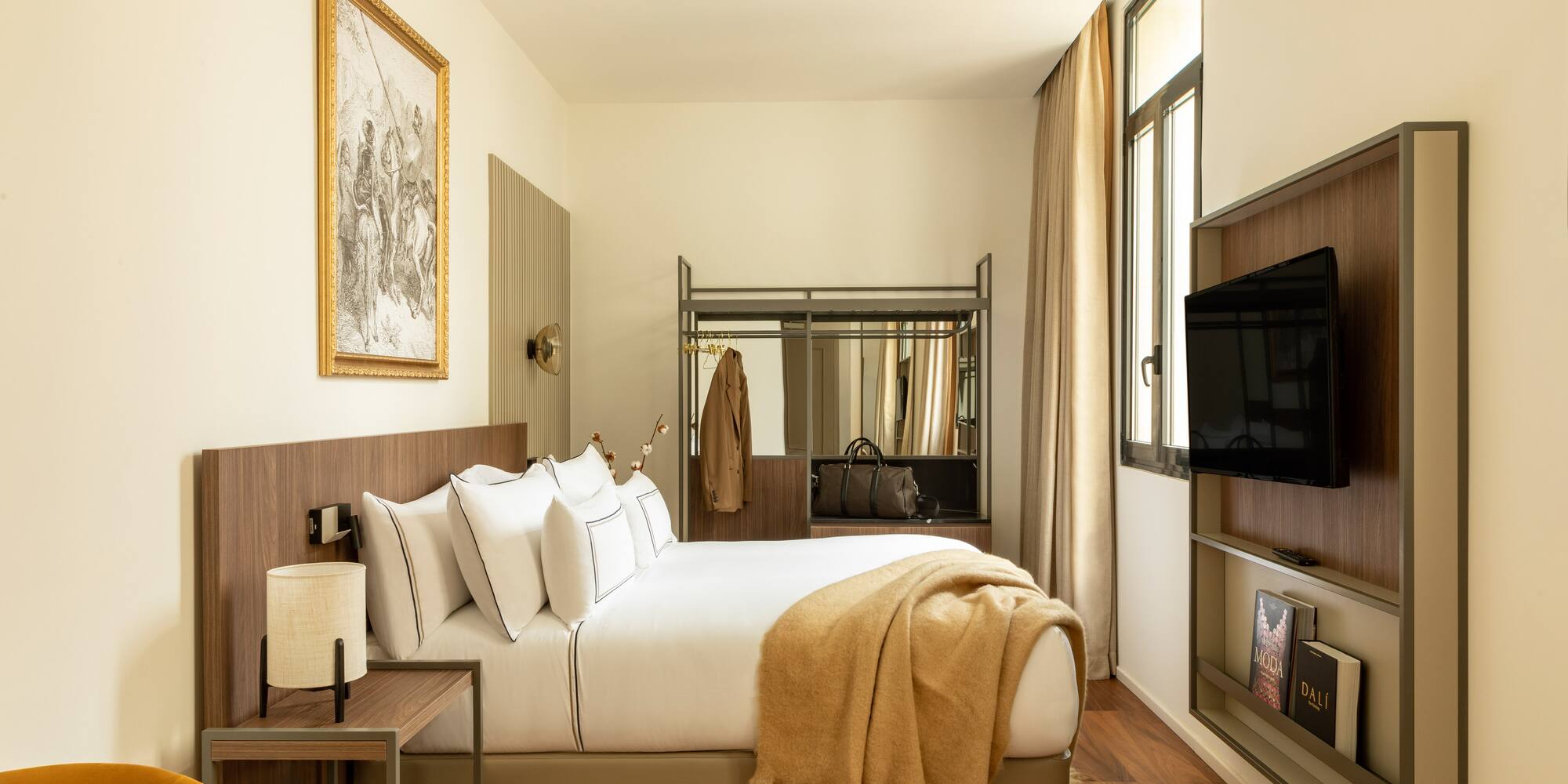 a bedroom with a bed and a television