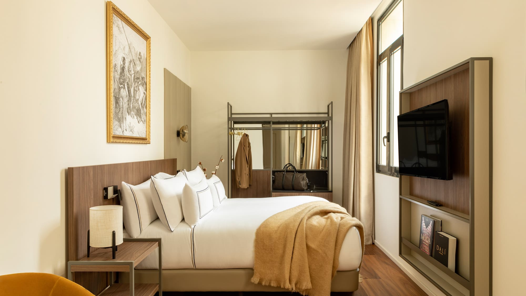 a bedroom with a bed and a television