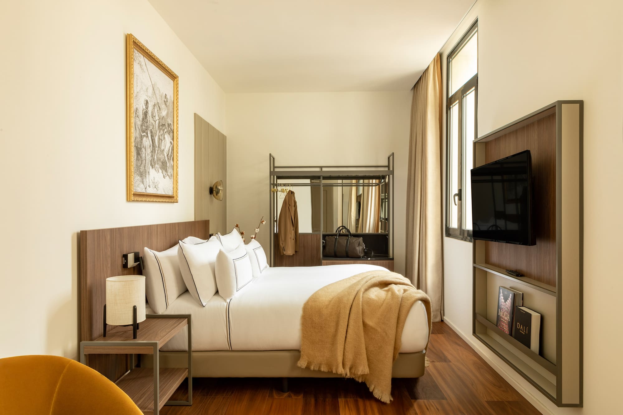 a bedroom with a bed and a television