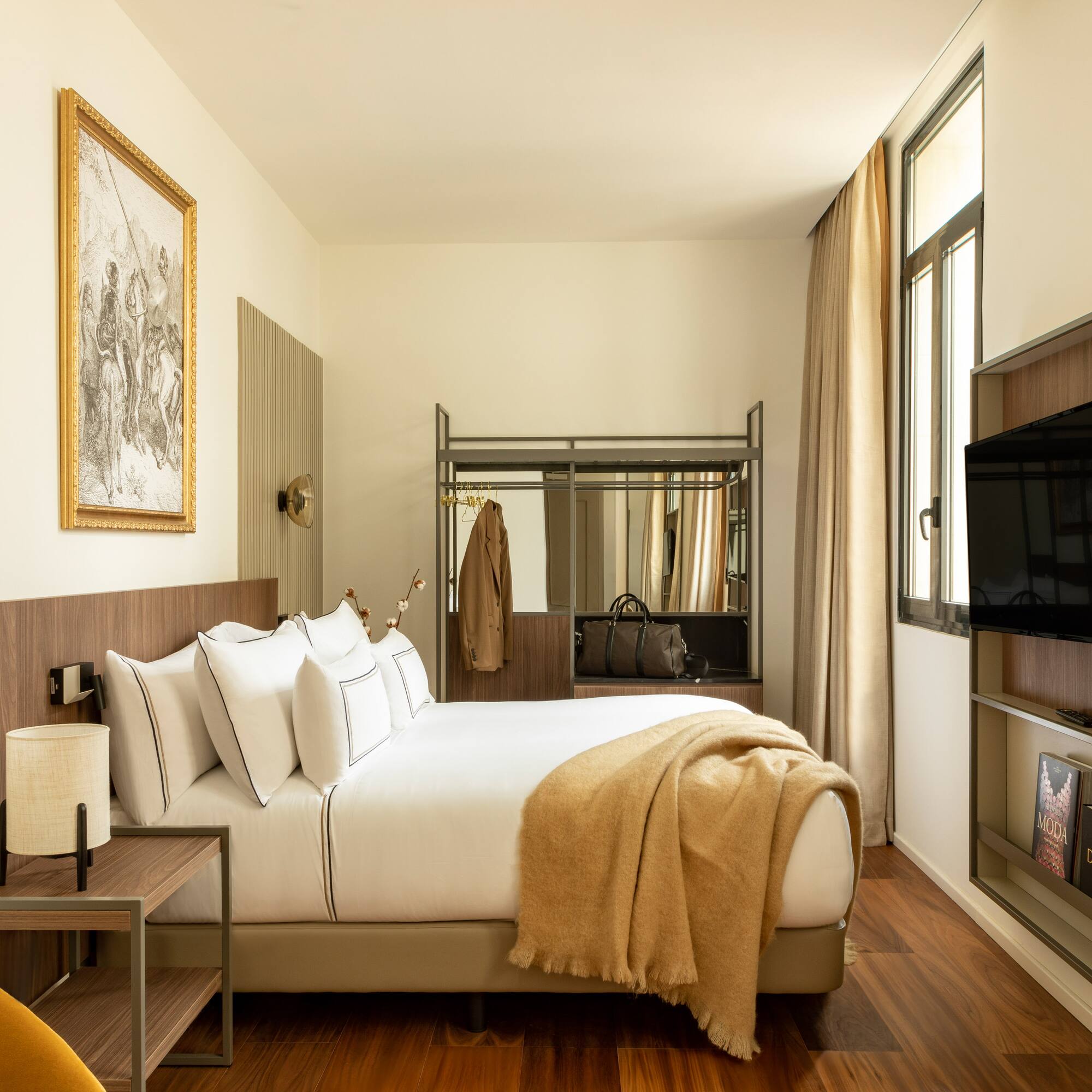 a bedroom with a bed and a television