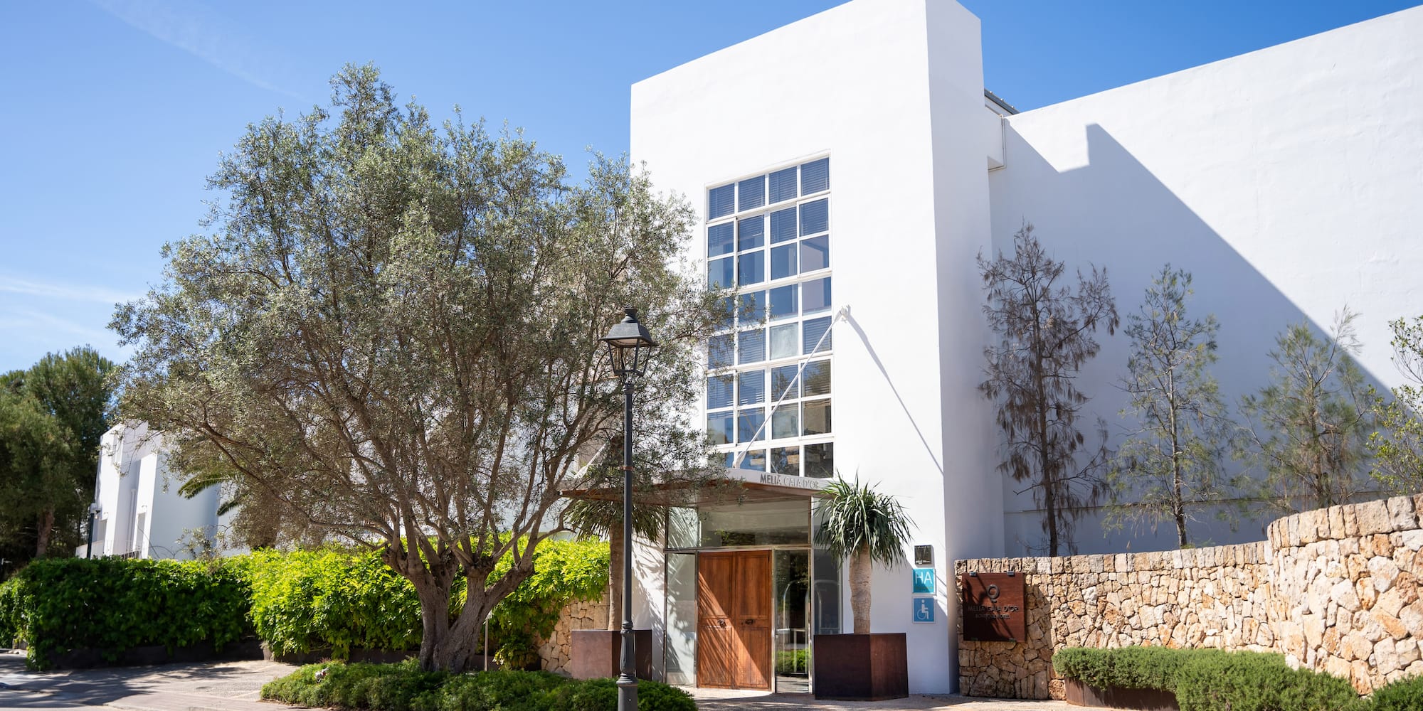 a white building with trees and bushes