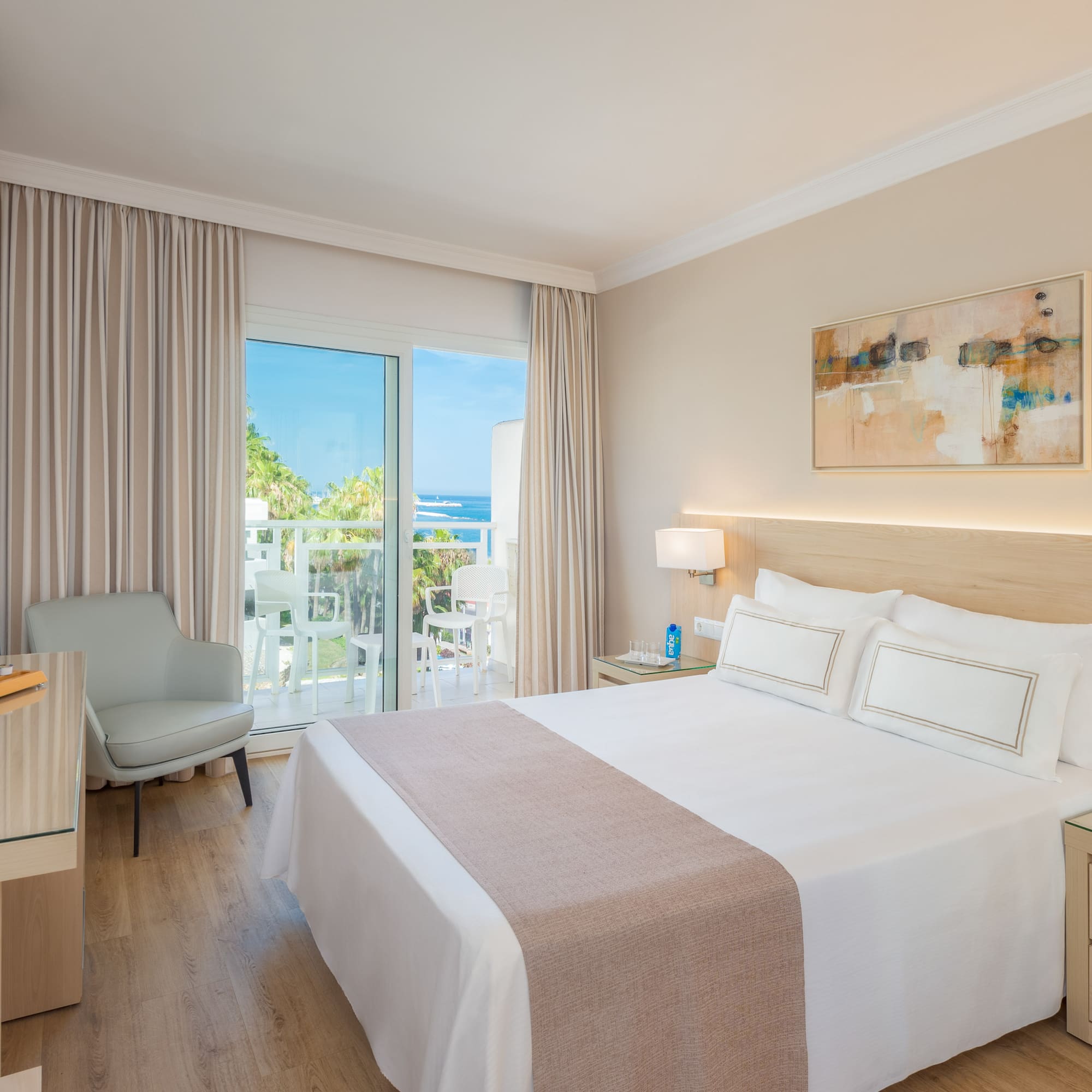 a bedroom with a bed and a desk and chair