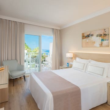 a bedroom with a bed and a desk and chair