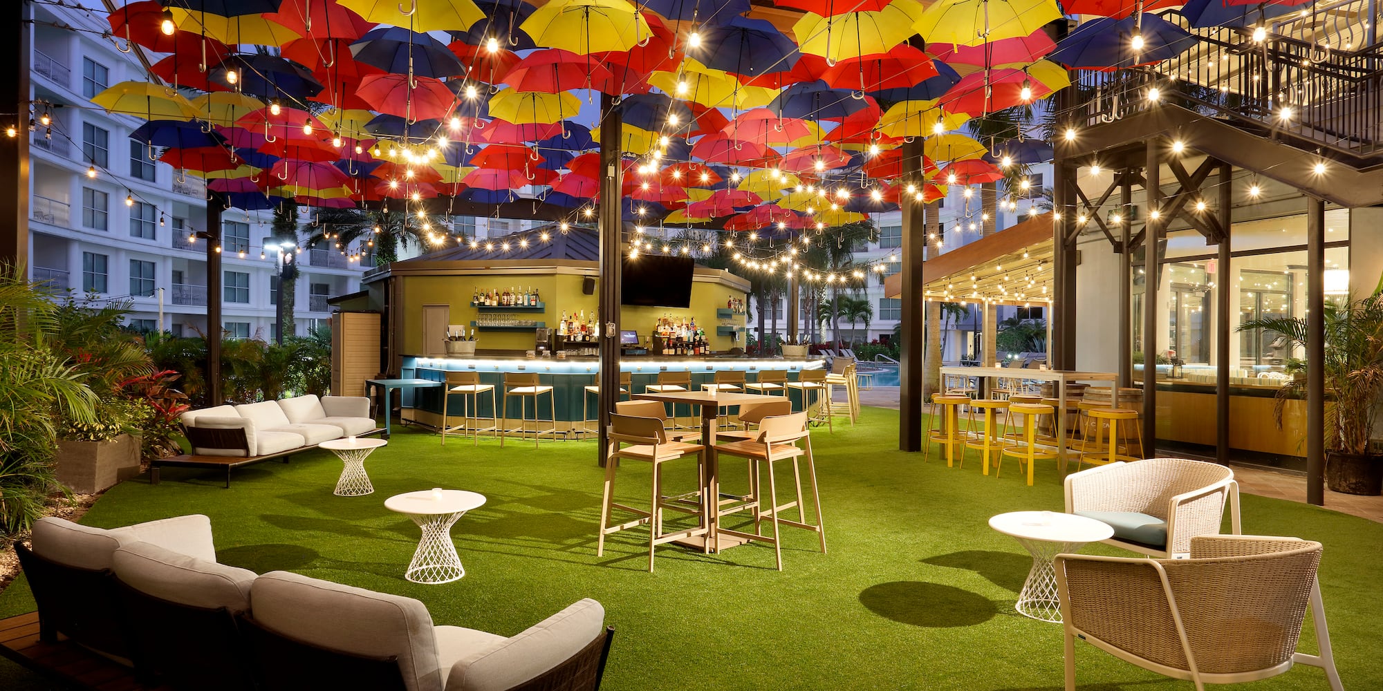 a patio with colorful umbrellas and tables
