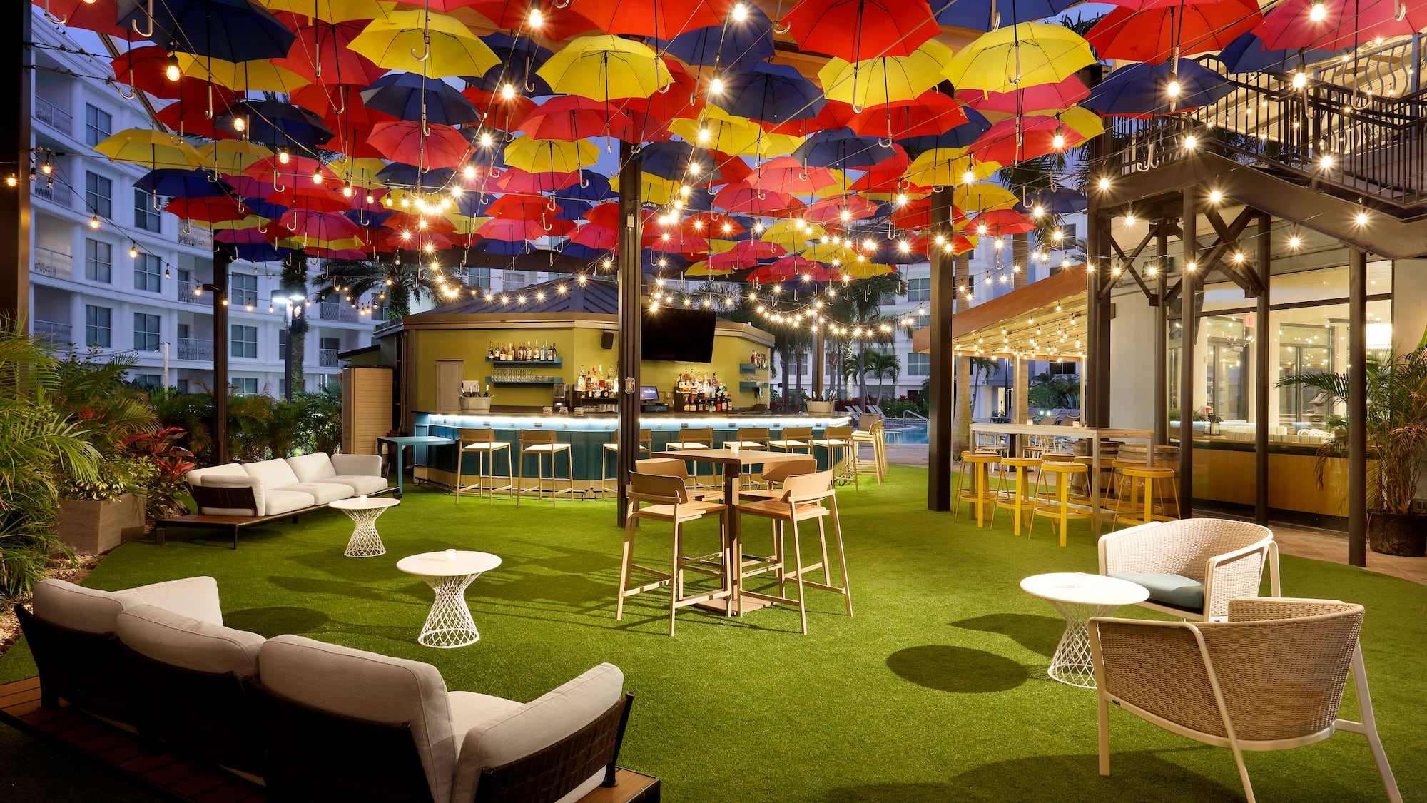 a patio with colorful umbrellas and tables