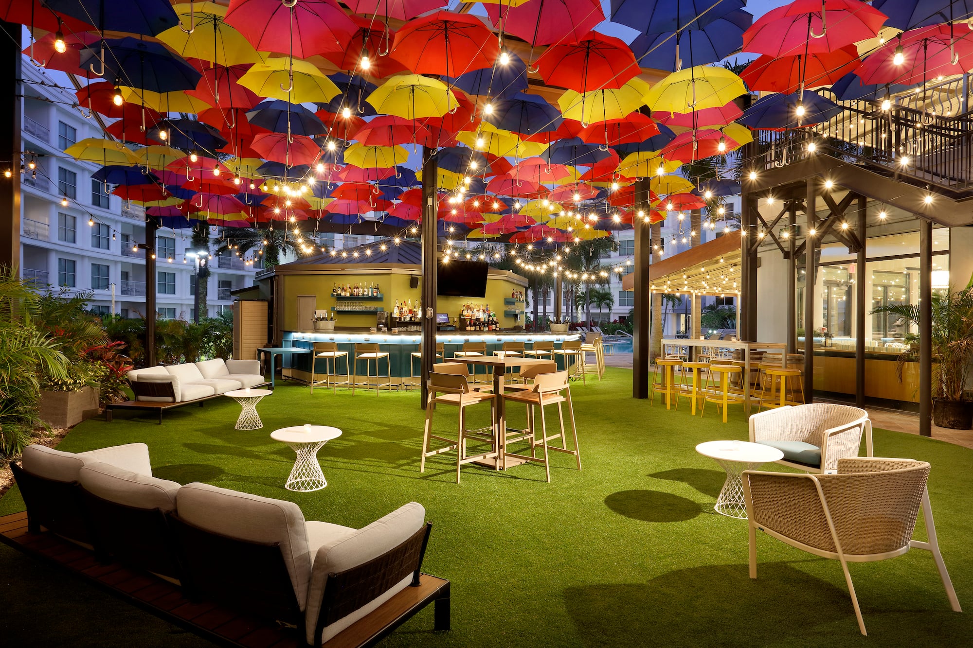 a patio with colorful umbrellas and tables