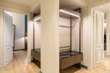 a closet with a bed and a shelf