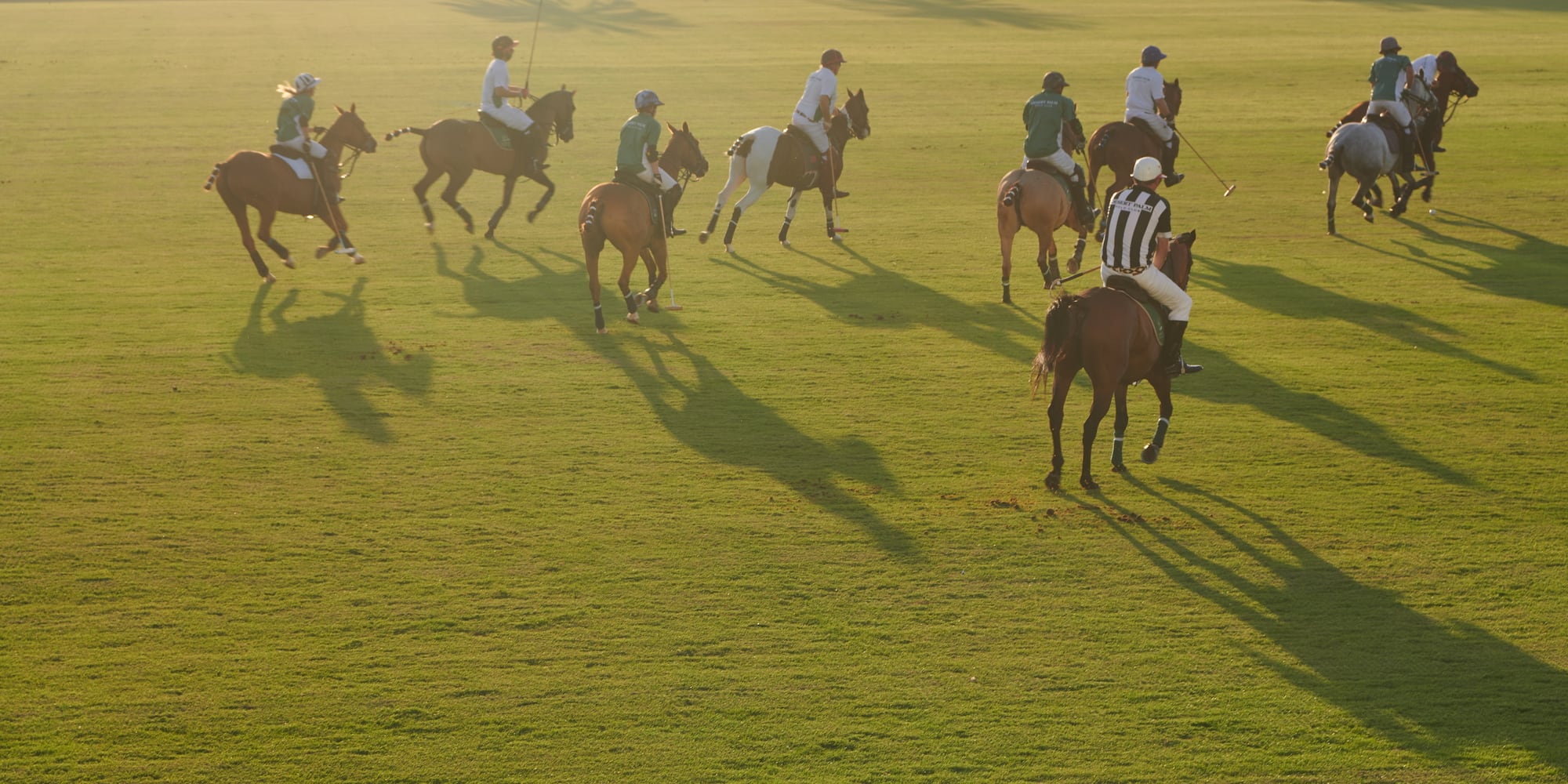 a group of people on horses on a field
