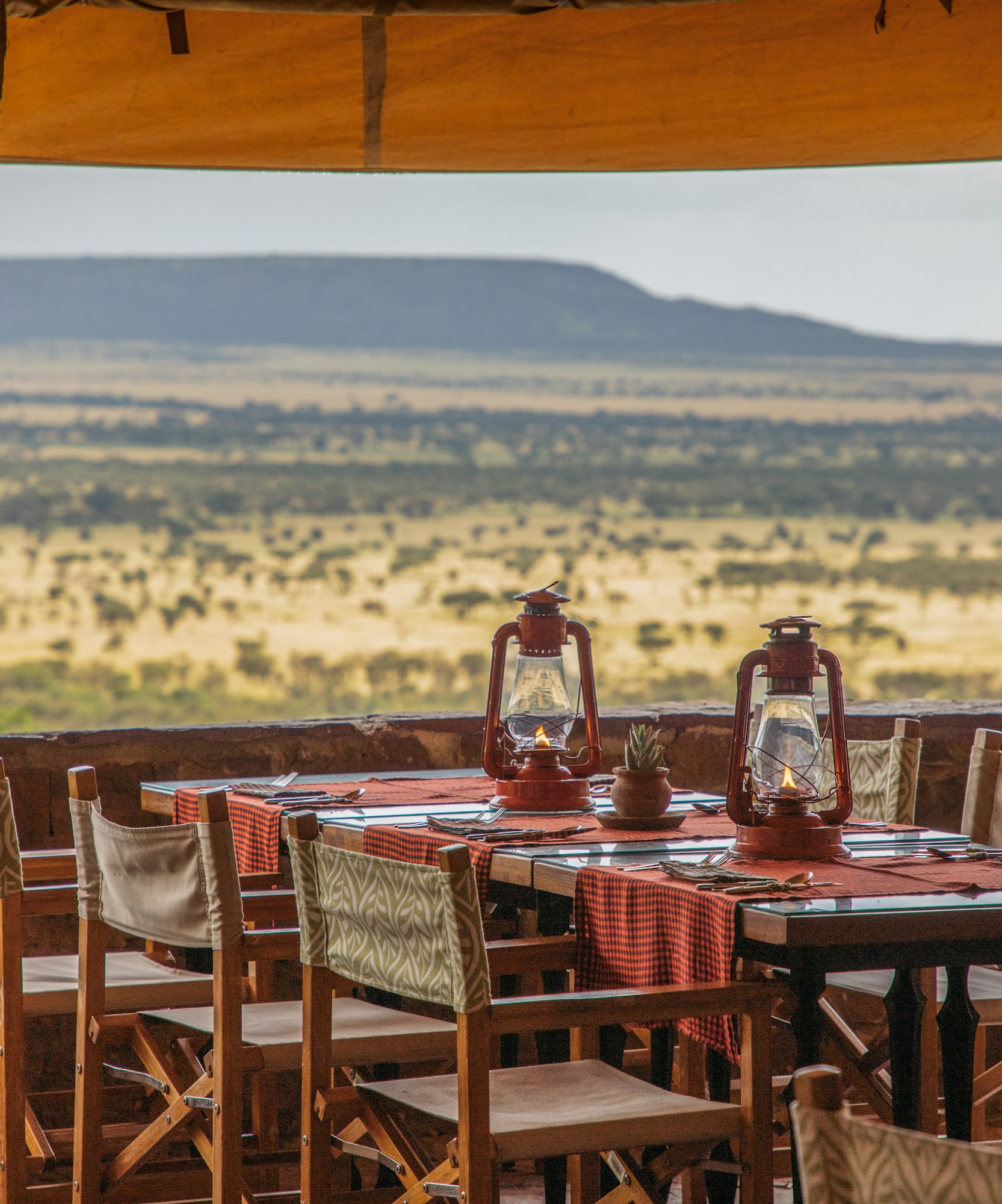a table with chairs and lanterns on it