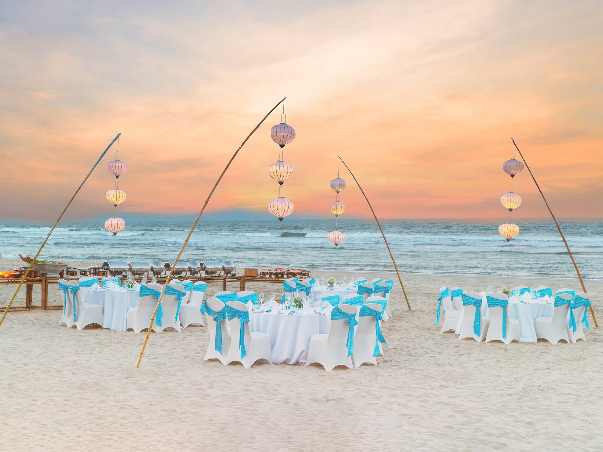 a group of tables and chairs on a beach