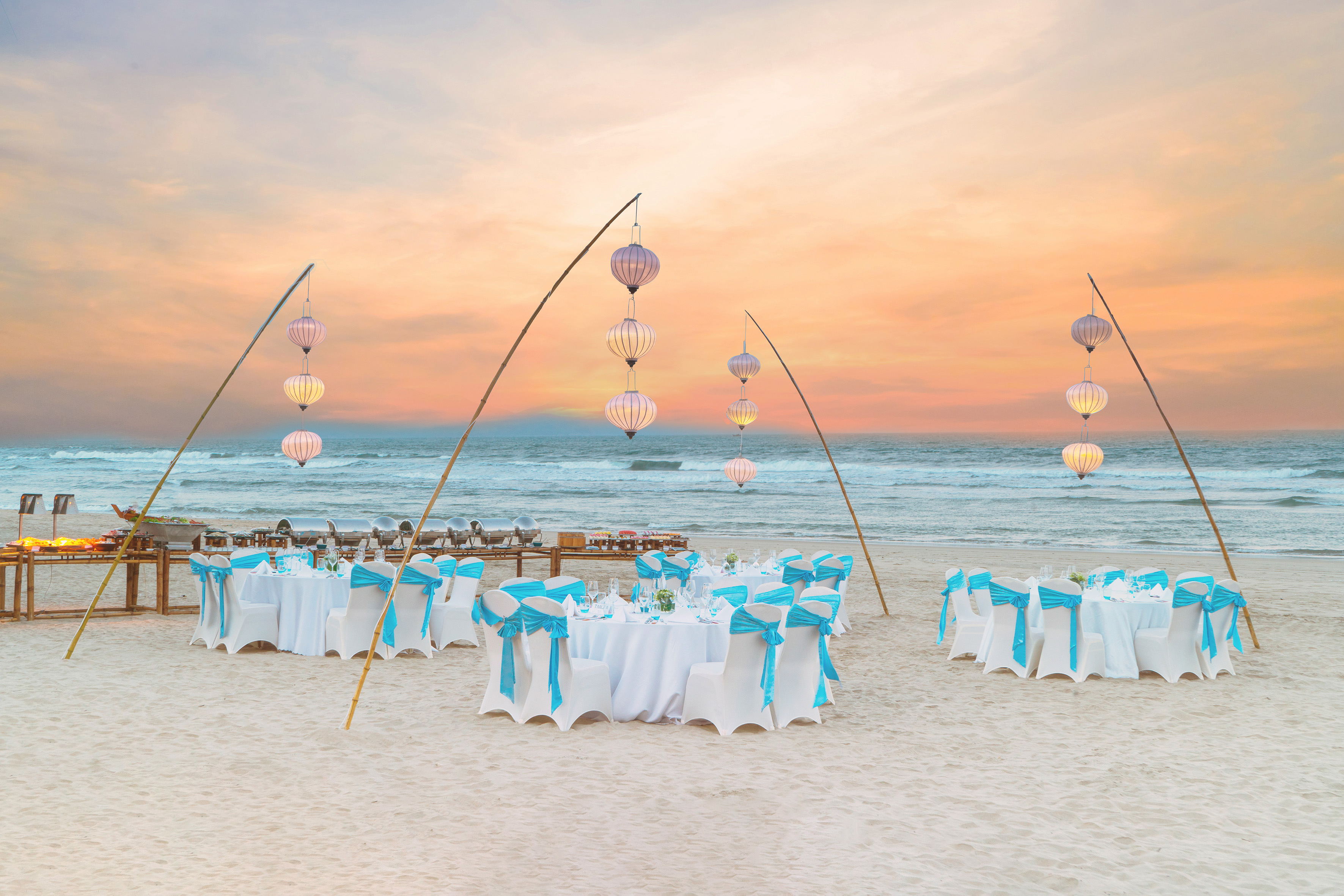 a group of tables and chairs on a beach