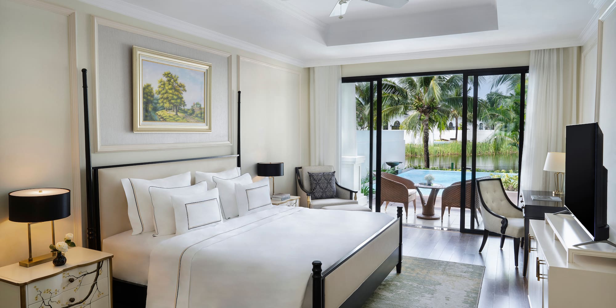 a bedroom with a bed and a pool in the background