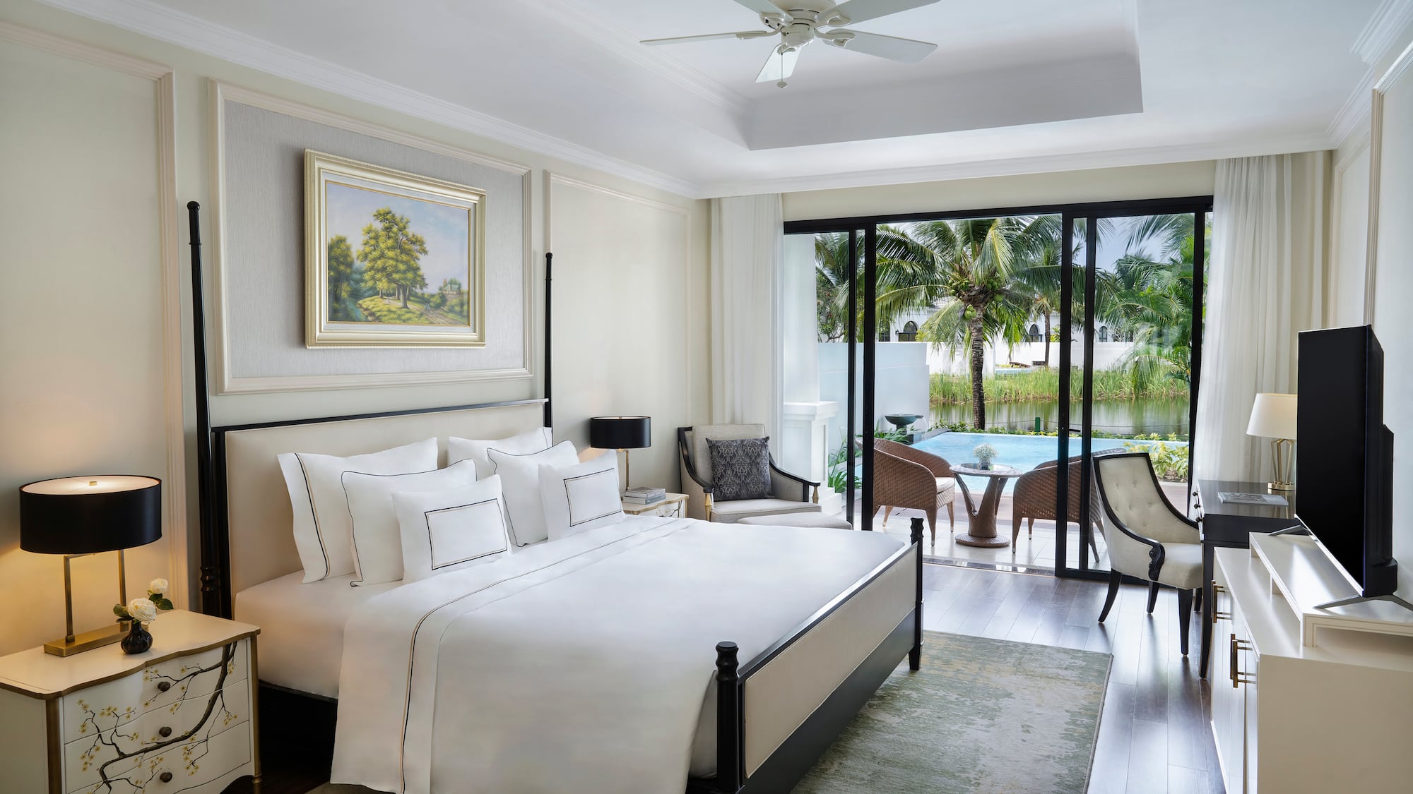 a bedroom with a bed and a pool in the background