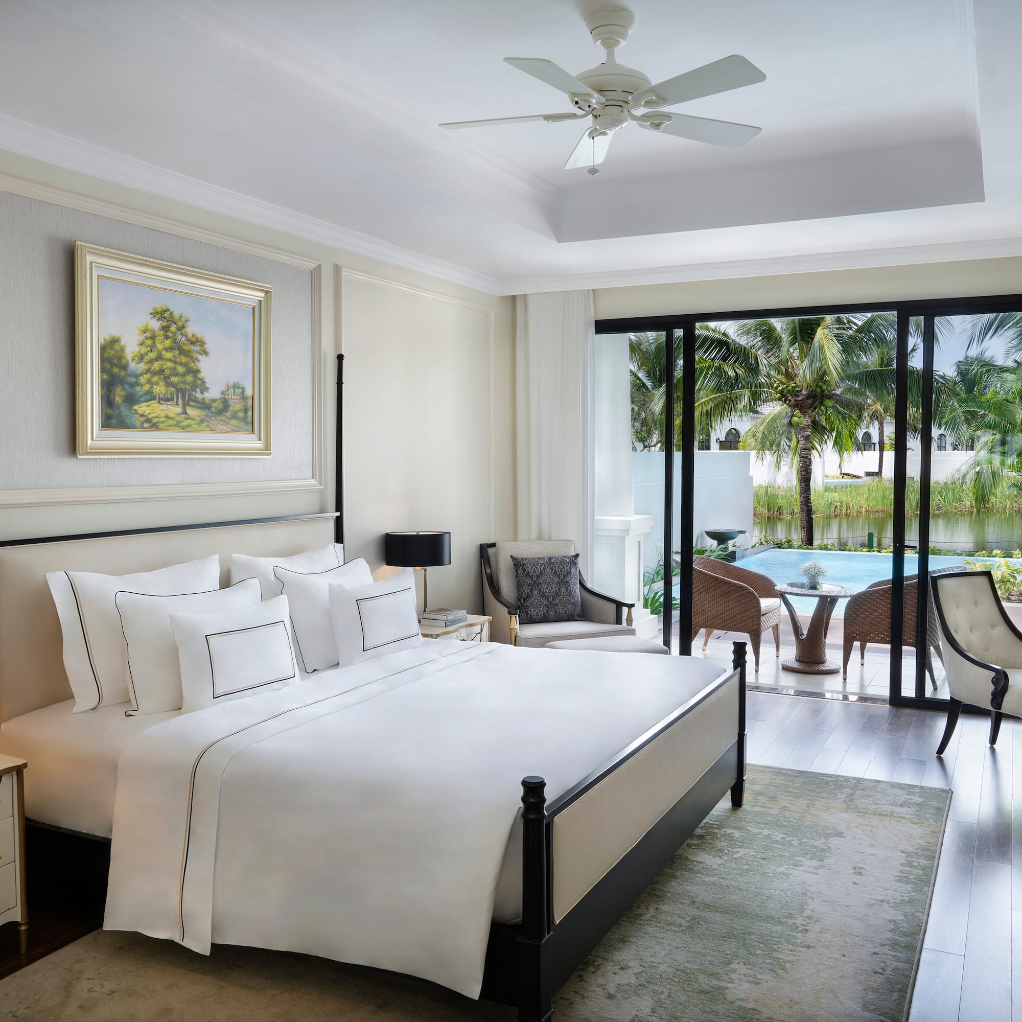 a bedroom with a bed and a pool in the background