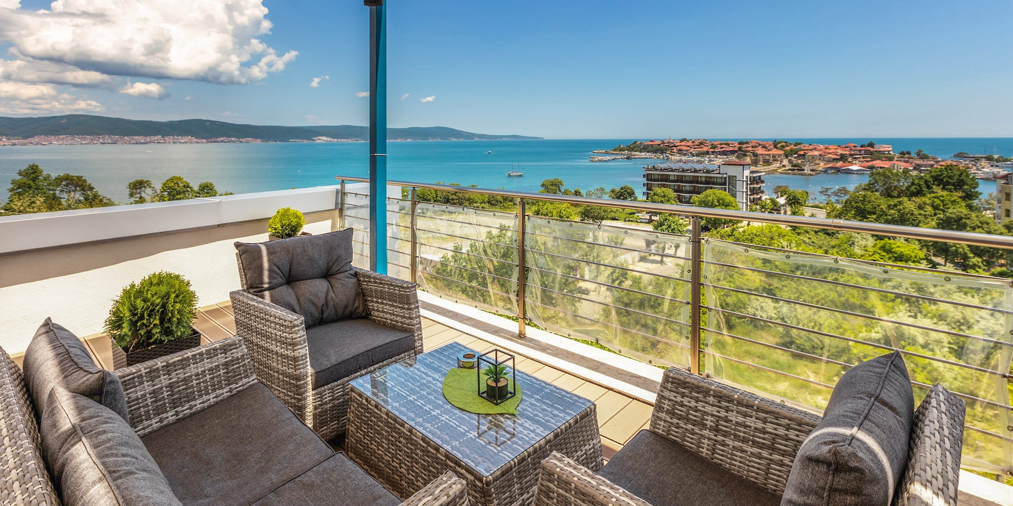 a patio with chairs and a table overlooking water